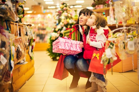 Mother and daughter buying Christmas decoration and gifts in a shop