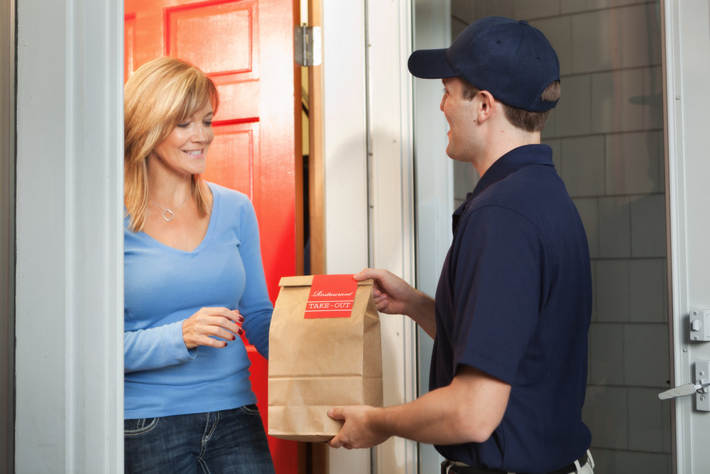 Subject: A take-out food delivery man delivering food package to customer's door.