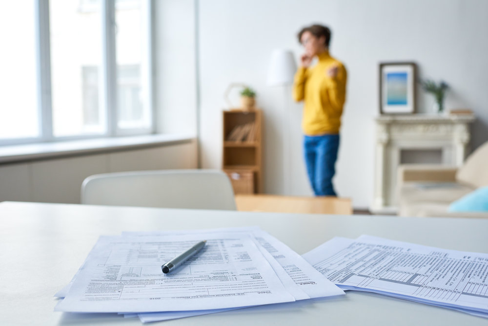 Close-up of splattering business papers and pen on white table at home of businesswoman