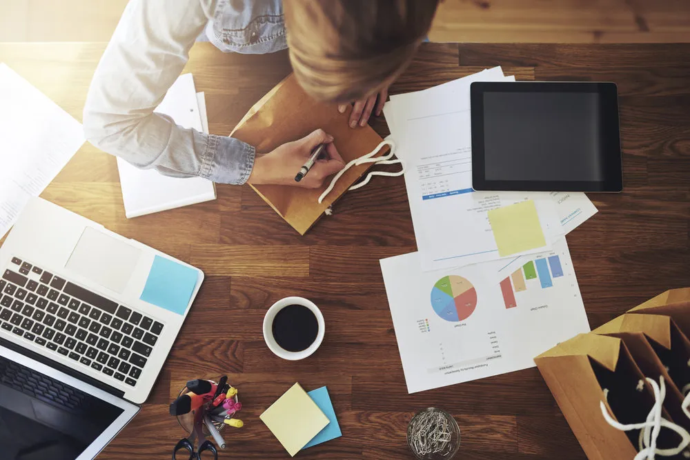 Young female entrepreneur working in a home office at her desk