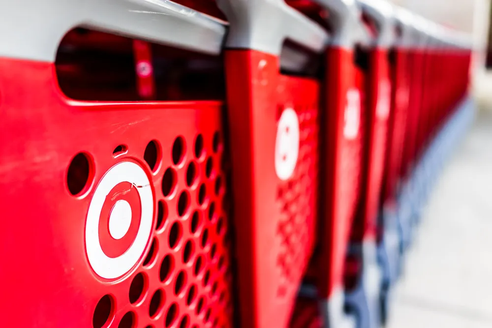 Fairfax: Many rows of red shopping carts outside by store with closeup by Target store parking lot