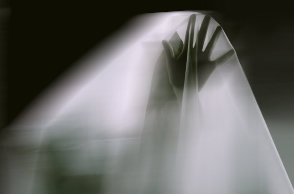 A ghostly apparition of a woman isolated on a black background
