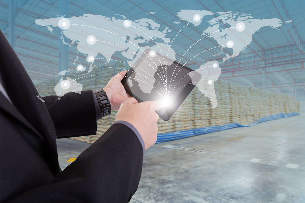 hand presses on world map with digital tablet,Business success strategy distribution product plan with warehouse background (Elements of this image furnished by NASA)