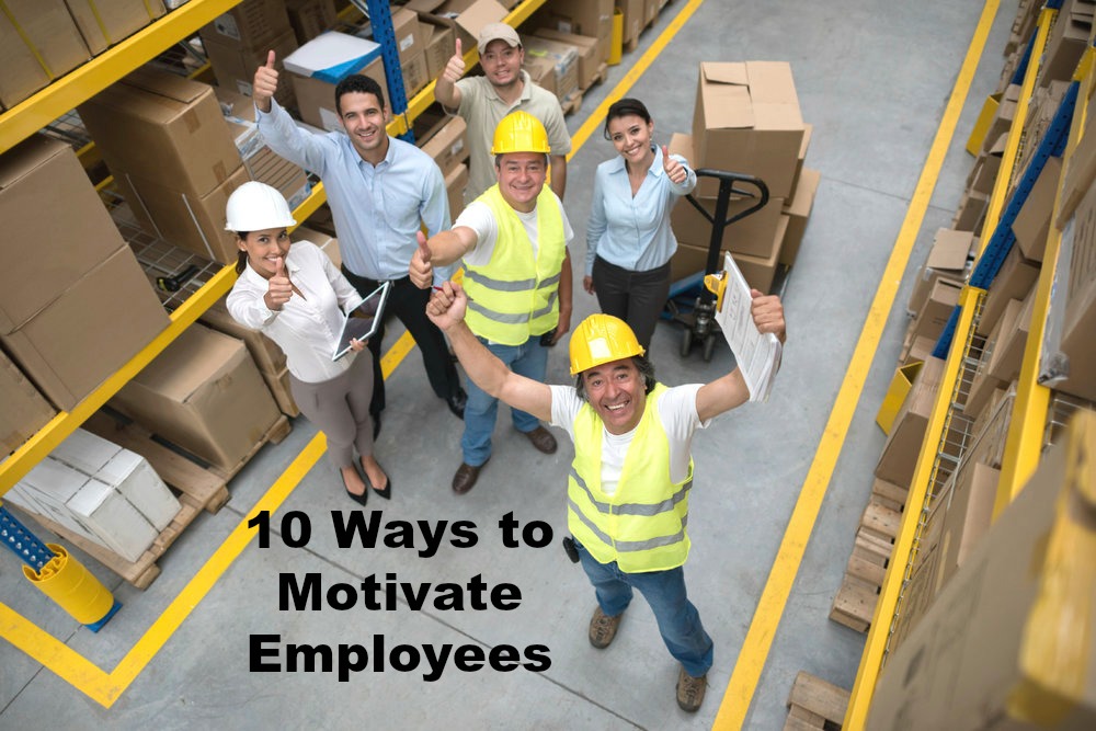 Happy group of workers at a warehouse with thumbs up and looking at the camera