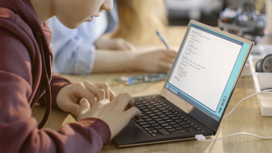 Smart Young Boy Works on a Laptop For His New Project in His Computer Science Class.