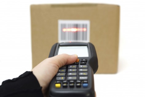 woman hold scanner and scans barcode with laser