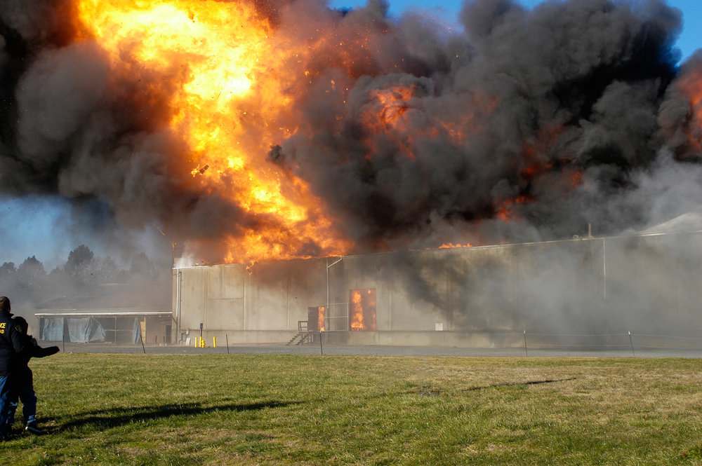 Explosive warehouse fire ignited by fireworks consumes all but the exterior concrete walls